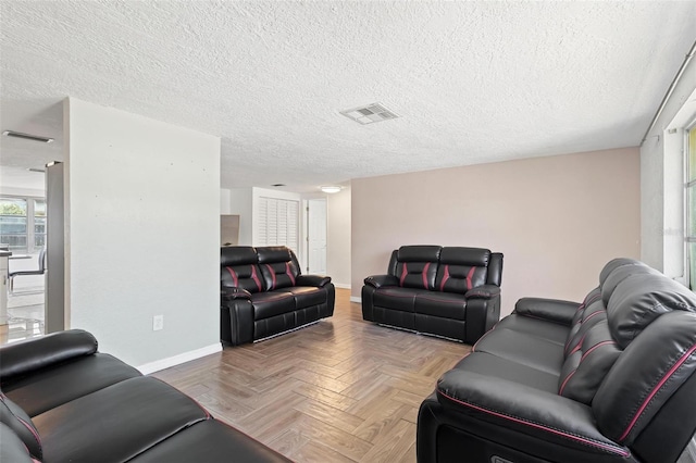 3654 Warbler Dr, New Port Richey, FL 34652 - living area featuring baseboards, visible vents, and a textured ceiling