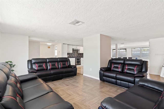 3654 Warbler Dr, New Port Richey, FL 34652 - living area with visible vents, baseboards, and a textured ceiling