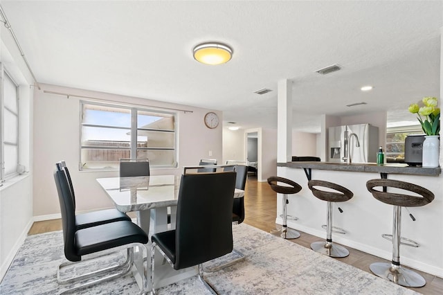 3654 Warbler Dr, New Port Richey, FL 34652 - dining room with baseboards, visible vents, and plenty of natural light