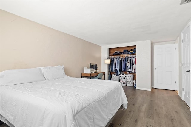 3654 Warbler Dr, New Port Richey, FL 34652 - bedroom featuring visible vents, baseboards, wood finished floors, and a closet