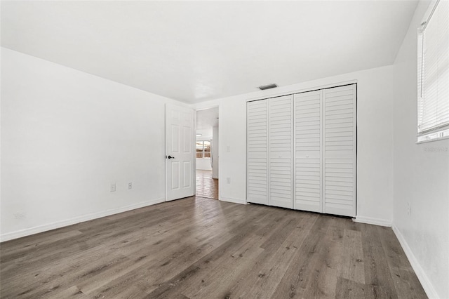 3654 Warbler Dr, New Port Richey, FL 34652 - unfurnished bedroom featuring wood finished floors and a closet