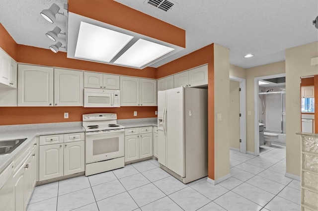 2023 Golfview Dr Unit 2023, Tarpon Springs, FL 34689 - kitchen featuring white appliances, white cabinets, light countertops, recessed lighting, and a textured ceiling