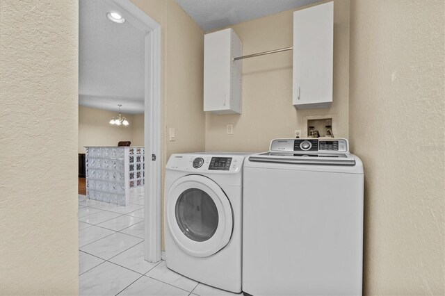 2023 Golfview Dr Unit 2023, Tarpon Springs, FL 34689 - laundry room featuring washing machine and clothes dryer, a textured wall, light tile patterned floors, and a chandelier