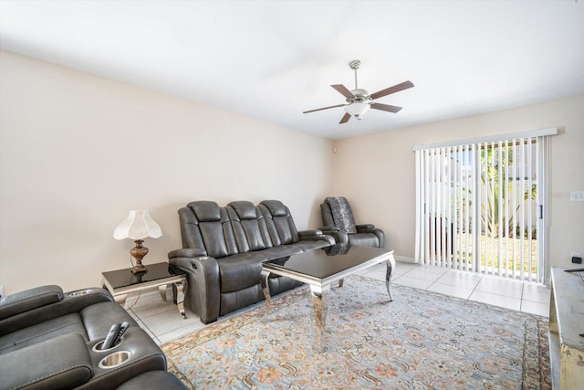 tiled living area with baseboards and a ceiling fan