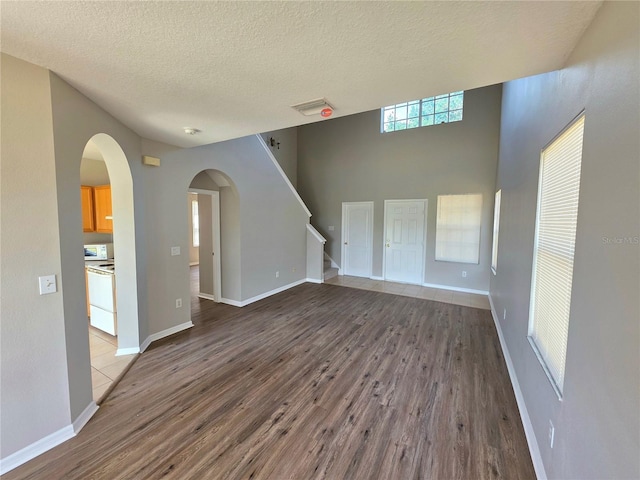 12604 Montford Ln, Riverview, FL 33579 - unfurnished living room with baseboards, wood finished floors, and a textured ceiling