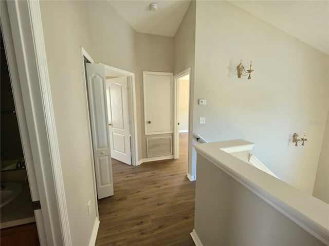 12604 Montford Ln, Riverview, FL 33579 - hallway with visible vents, baseboards, dark wood-style floors, and an upstairs landing