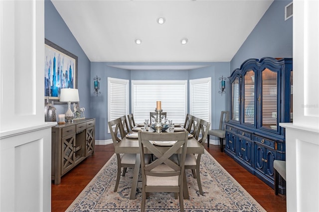 dining area featuring dark wood-style flooring, visible vents, recessed lighting, and vaulted ceiling