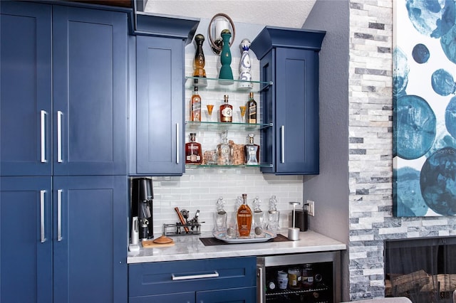 bar featuring beverage cooler, a bar, and decorative backsplash