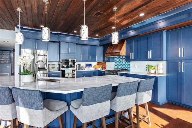 kitchen with light stone counters, a sink, blue cabinetry, and wooden ceiling
