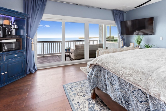 bedroom featuring wood finished floors and access to outside