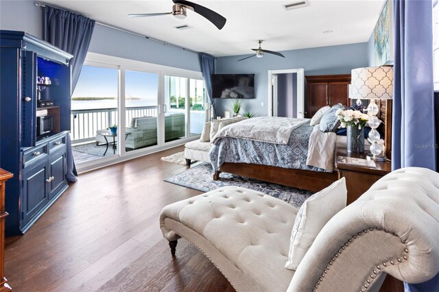 bedroom featuring a ceiling fan, visible vents, access to outside, and wood finished floors