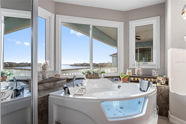 full bath with a tub with jets and a water view