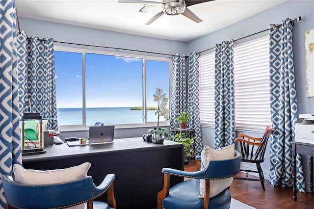 home office with visible vents, wood finished floors, a ceiling fan, and plenty of natural light