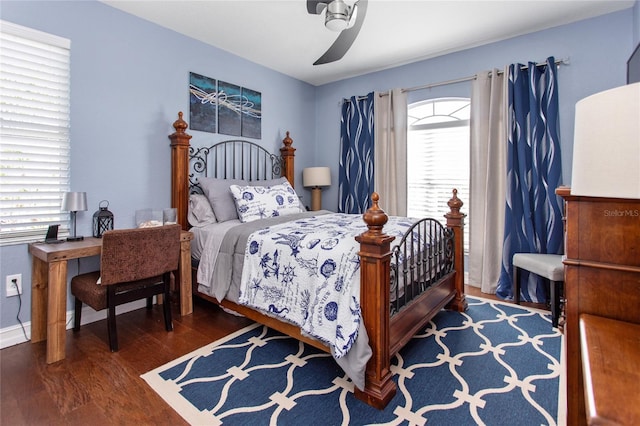 bedroom with a ceiling fan, multiple windows, and wood finished floors
