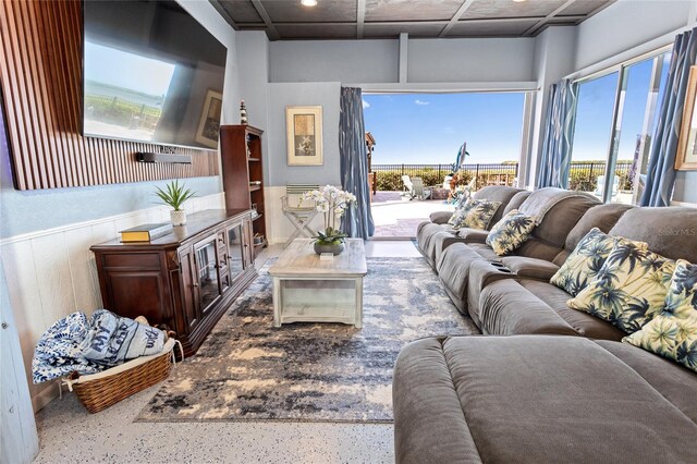 living room featuring a wainscoted wall and a wealth of natural light