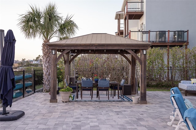 view of patio / terrace with a gazebo, outdoor dining area, and a fenced backyard