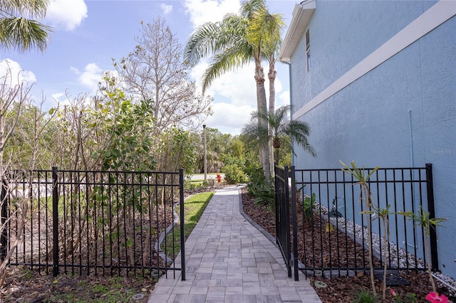 view of home's community featuring fence