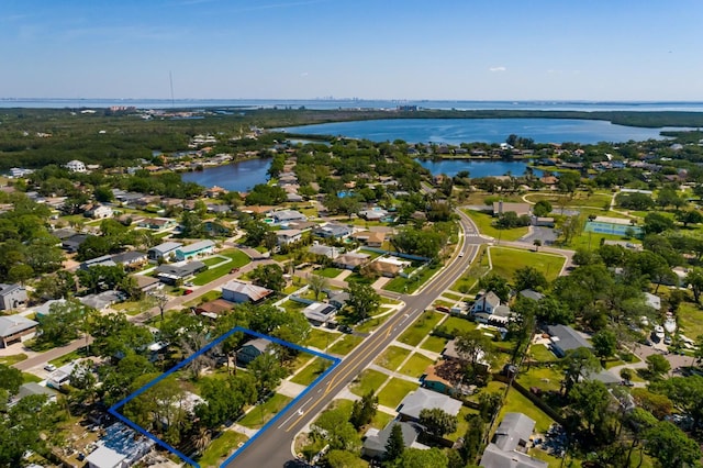 drone / aerial view with a water view and a residential view