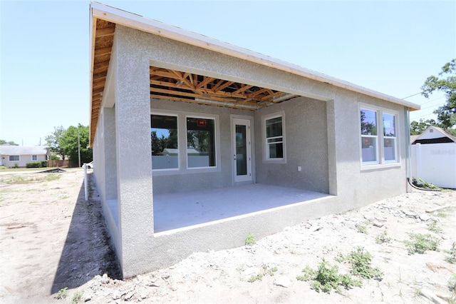 4244 11th Ave N, Saint Petersburg, FL 33713 - rear view of property featuring stucco siding and a patio