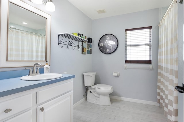 full bath with vanity, visible vents, toilet, wood finished floors, and baseboards