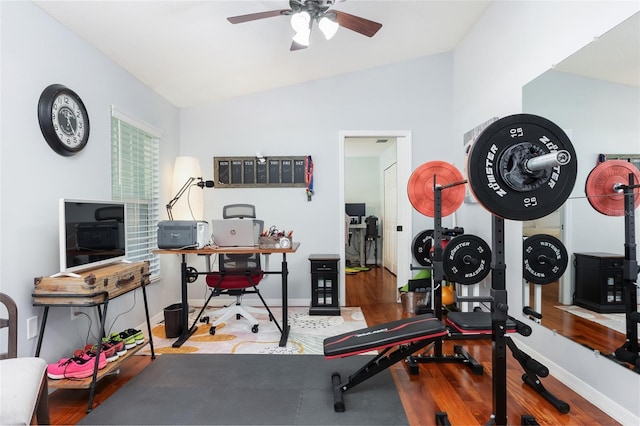 workout room with wood finished floors, baseboards, a ceiling fan, and lofted ceiling