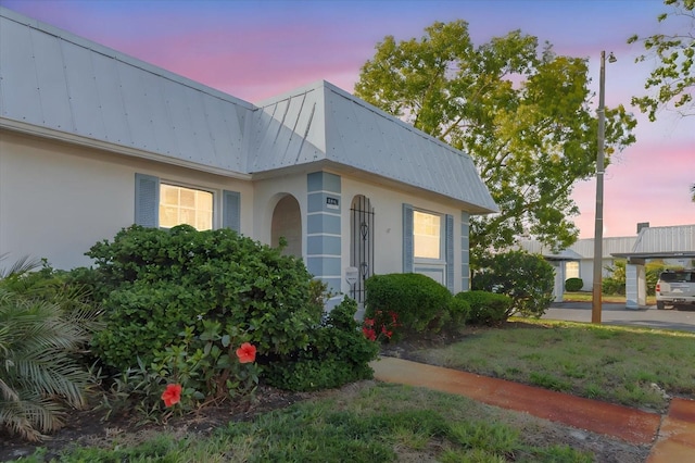 4235 Tamargo Dr Unit 4235, New Port Richey, FL 34652 - view of front of home featuring stucco siding and a metal roof