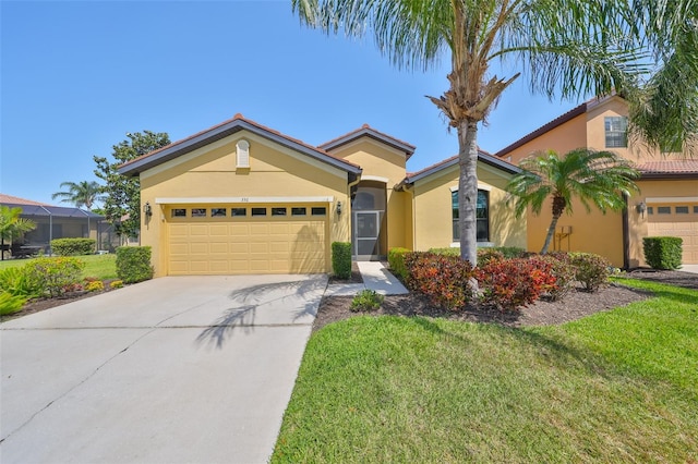 336 Silver Falls Dr, Apollo Beach, FL 33572 - view of front of house featuring a garage, driveway, stucco siding, and a front lawn