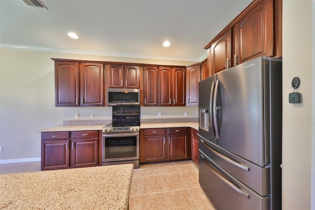 336 Silver Falls Dr, Apollo Beach, FL 33572 - kitchen with recessed lighting, light tile patterned floors, a textured ceiling, and appliances with stainless steel finishes