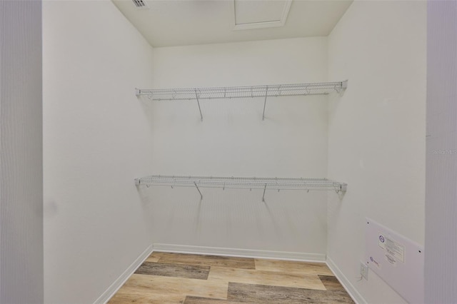 336 Silver Falls Dr, Apollo Beach, FL 33572 - walk in closet with attic access, light wood finished floors, and visible vents