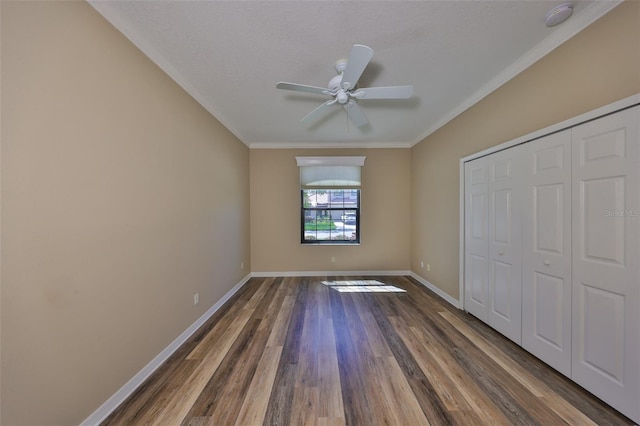 336 Silver Falls Dr, Apollo Beach, FL 33572 - unfurnished bedroom with ornamental molding, baseboards, a closet, and wood finished floors