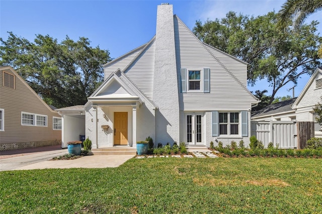 view of front of property featuring a front yard and a chimney