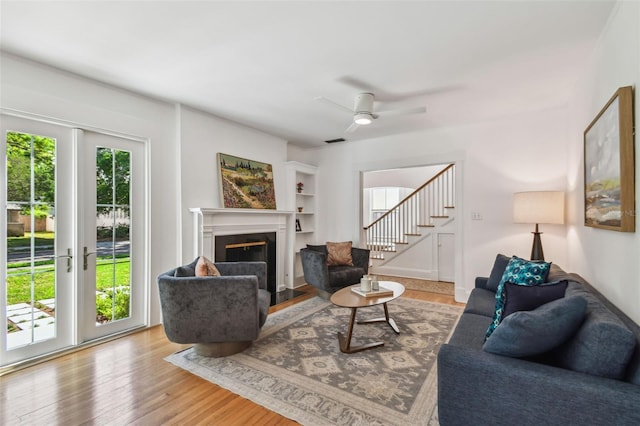 living room featuring a wealth of natural light, stairway, visible vents, and wood finished floors