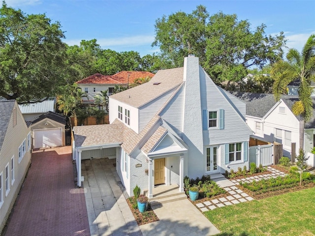 view of front of property with a chimney, an outdoor structure, fence, french doors, and roof with shingles