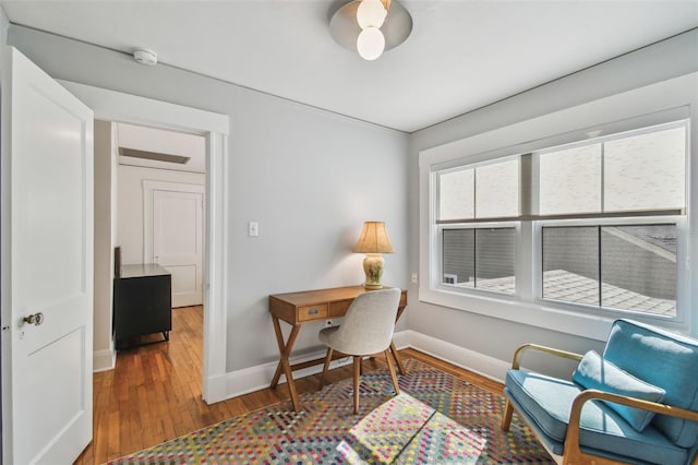 office space with wood finished floors and baseboards