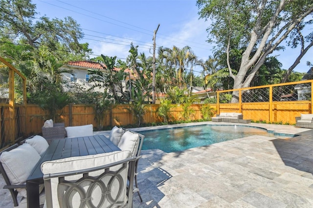 view of swimming pool with a patio area, outdoor lounge area, a fenced backyard, outdoor dining area, and a fenced in pool