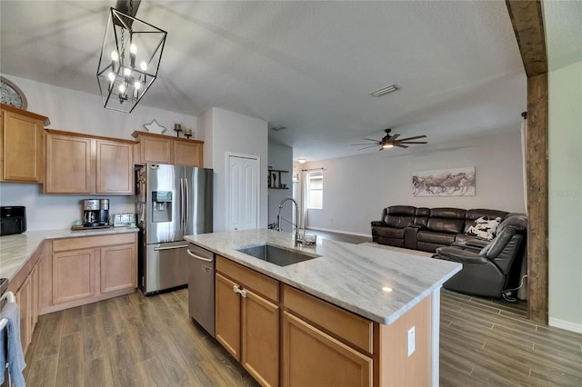 7511 Turtle View Dr, Ruskin, FL 33573 - kitchen featuring stainless steel appliances, wood finished floors, ceiling fan, and light stone countertops