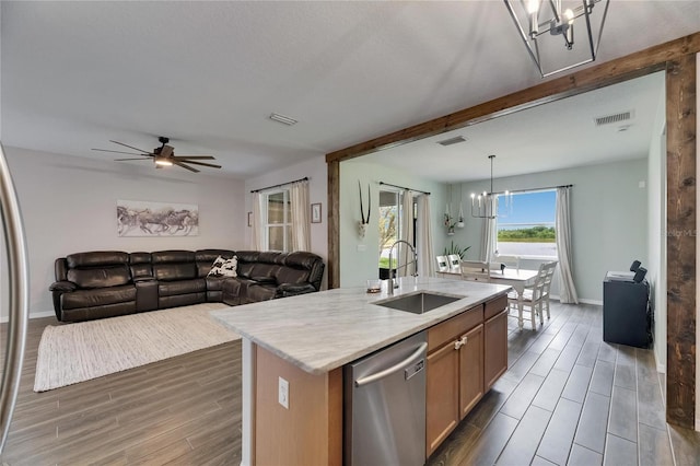 7511 Turtle View Dr, Ruskin, FL 33573 - kitchen featuring stainless steel dishwasher, a chandelier, dark wood-style floors, a ceiling fan, and a center island with sink