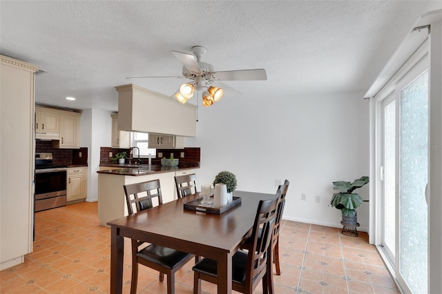 5207 Moeller Ave, Sarasota, FL 34233 - dining space with a textured ceiling, a ceiling fan, and light tile patterned flooring
