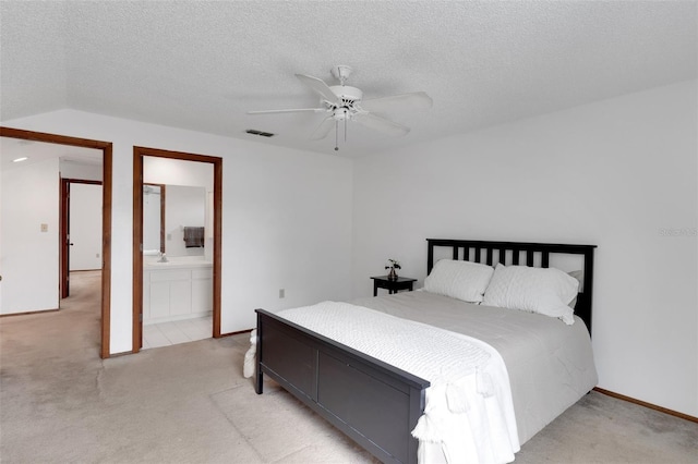 5207 Moeller Ave, Sarasota, FL 34233 - carpeted bedroom with visible vents, a ceiling fan, ensuite bathroom, and a textured ceiling