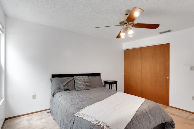 5207 Moeller Ave, Sarasota, FL 34233 - bedroom with visible vents, baseboards, a closet, a textured ceiling, and light carpet