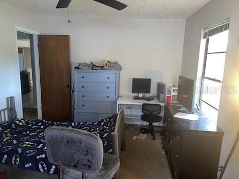 bedroom with a textured ceiling and ceiling fan