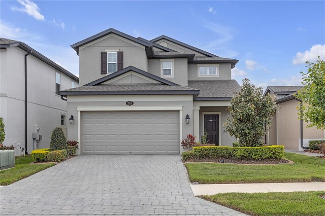19926 Stone Pine Cir, Lutz, FL 33558 - traditional-style home with decorative driveway, stucco siding, a shingled roof, and a front lawn