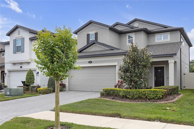 19926 Stone Pine Cir, Lutz, FL 33558 - view of front of property featuring decorative driveway, stucco siding, central AC, and a front lawn