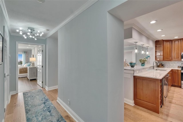 interior space with light stone counters, backsplash, open shelves, brown cabinets, and a sink
