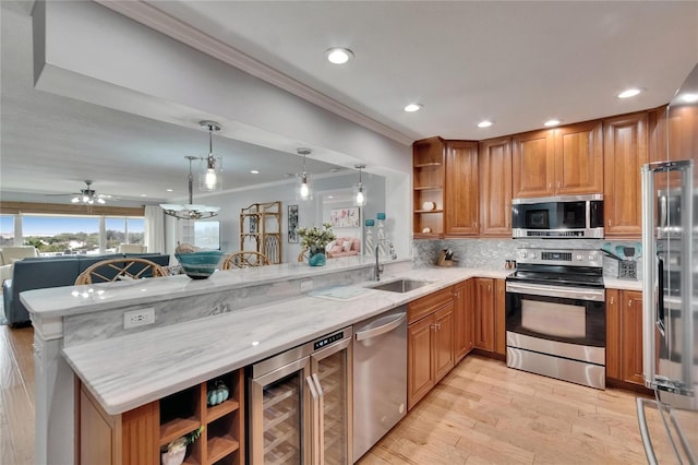 kitchen with a sink, open shelves, appliances with stainless steel finishes, and beverage cooler