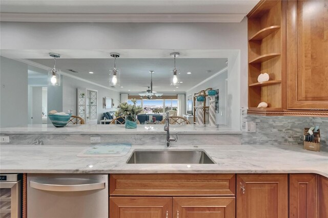 kitchen with crown molding, light stone countertops, brown cabinets, stainless steel dishwasher, and a sink