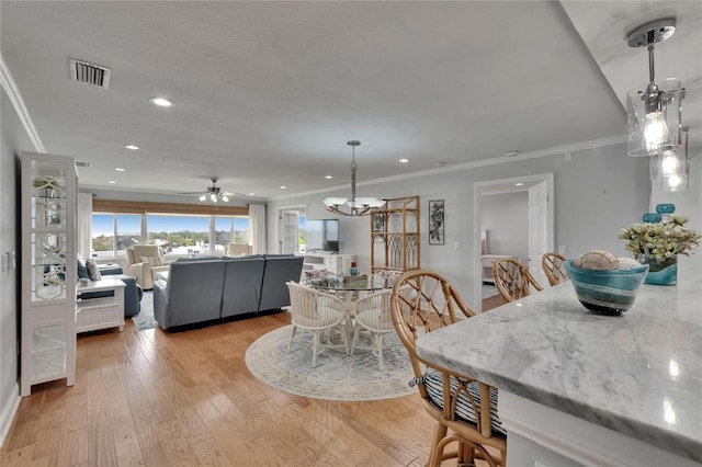 dining area featuring ornamental molding, light wood-style flooring, recessed lighting, and visible vents