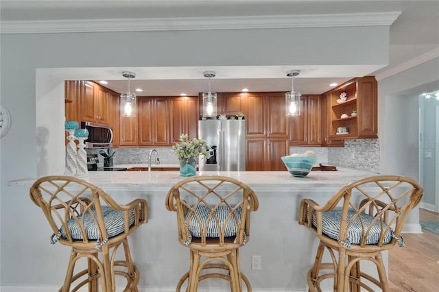 kitchen featuring brown cabinets, open shelves, appliances with stainless steel finishes, and a peninsula