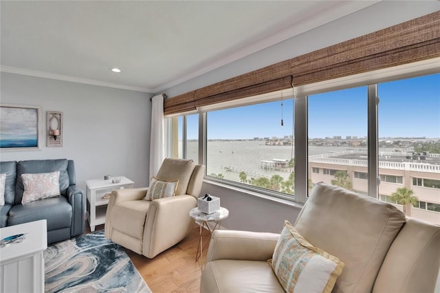 living room with ornamental molding, recessed lighting, a view of city, and wood finished floors