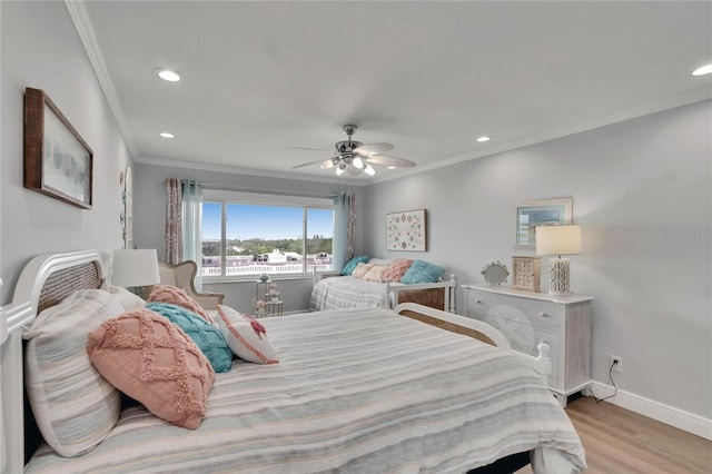 bedroom featuring light wood-type flooring, crown molding, baseboards, and recessed lighting